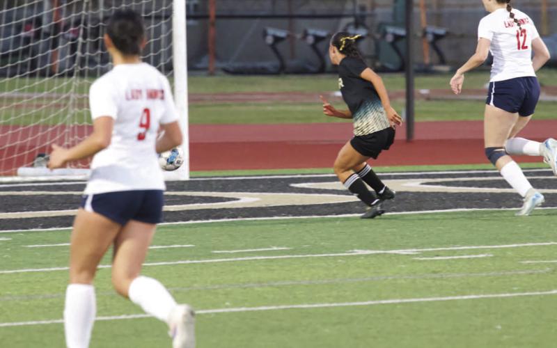 Sneaks the ball into the net