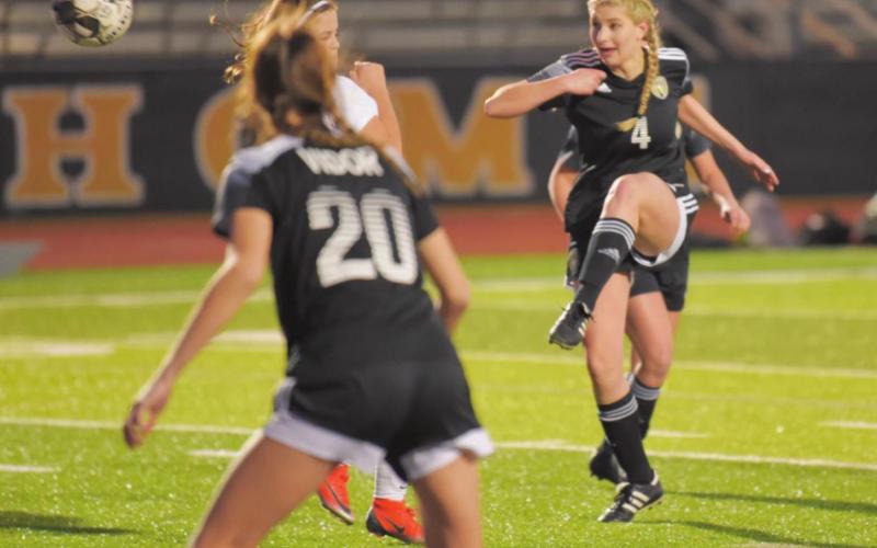 Kinley LaPray takes a shot in Tuesday’s game with BC. Lady Pirate Jaden Lee #20 watches in the foreground.