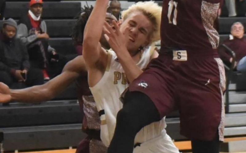 Sophomore Pirate Westin Baker is squeezed between two Slsbee players Friday in the varsity’s district game at Vidor.