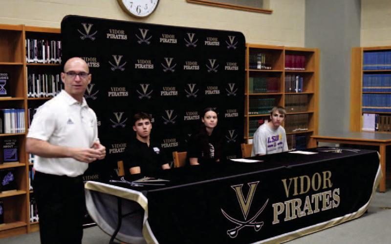 VISD Athletic Director Dwayne DuBois introduces Daigan Venable, Madison Perkins and Caden Williamson at the college signing ceremony held in the VHS Library Friday.