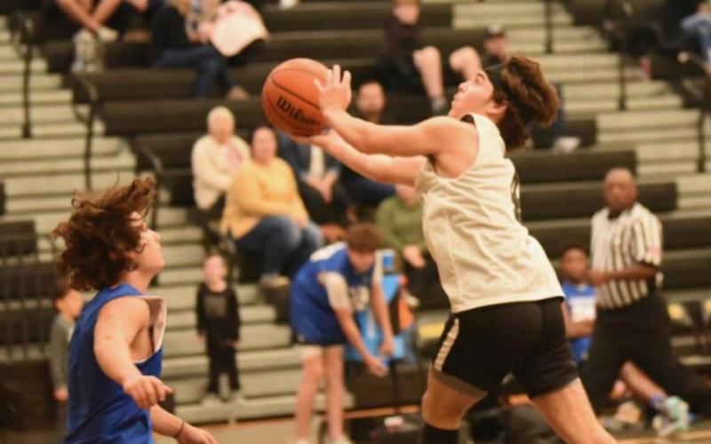 Photo by Randall Luker Blayne Holcom takes a shot versus Kelly Saturday.