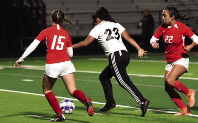 Lady Pirate Yamile Delgado, #23, shoots and scores in traffic in the junior varsity match versus the Lady Cardinals Friday. Photo by Randall Luker