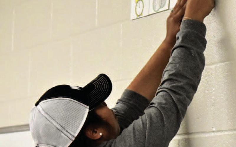 First-grade OFE teacher Janelle Haley was busy readying her classroom for students Monday and said she and the students have eagerly waited the move. Photo by Randall Luker