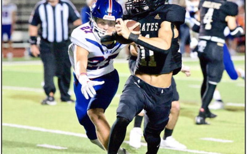 Bryce Dubose eluded numerous Trojan defenders to score on a Pick 6 Friday versus the Trinity Christian Academy Trojans. Photo by Randall Luker