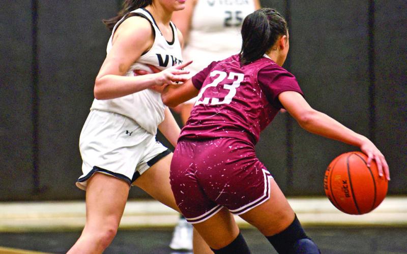 Guarding a Tiger A Silsbee Lady Tiger tries to get past Vidor’s Kinsey Dillard in Fridays’ game at Pirate Gym.