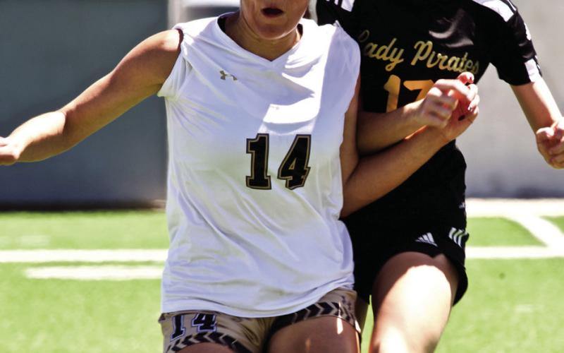 Eyes on the Ball Lady Pirate Jordyn Fowler and a Giddings Lady Buff concentrate on the ball as they await a throw in.