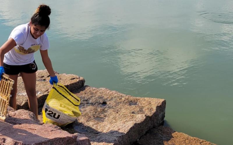 A volunteer picks up debris during the Adopt-A-Beach Fall Cleanup near North Beach, Corpus Christi, Texas. Courtesy Photo