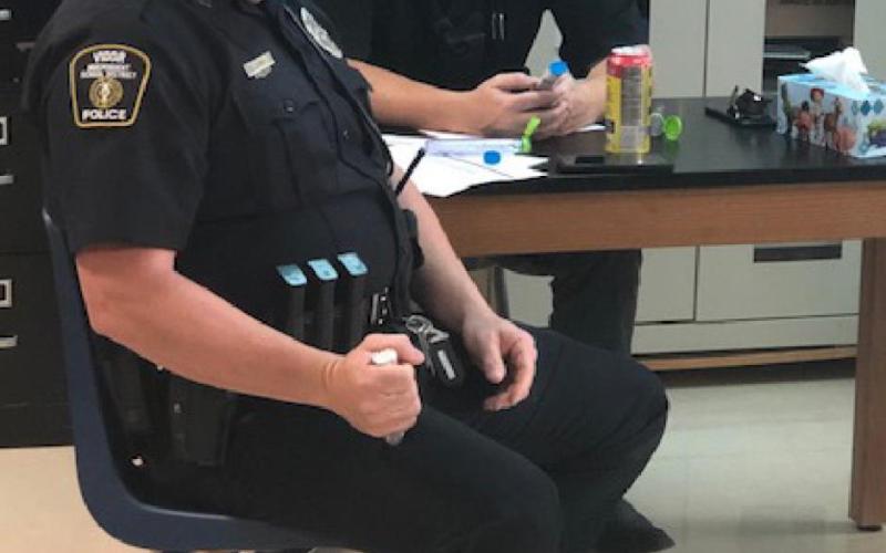Officer James Roy learns how to use an Epi Pen while Officer Keith Thomas studies proper usage s... and when to use the pen.