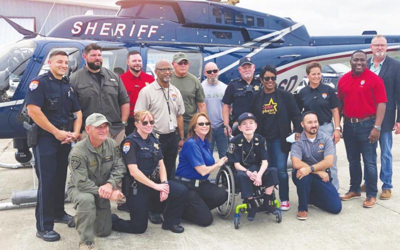 Jefferson County Zena Sheriff Stephens took Weston on a helicopter ride, then presented him with a swat helmet, a patch, and a challenge coin. There were over one hundred law enforcement officials on hand to celebrate with Weston.