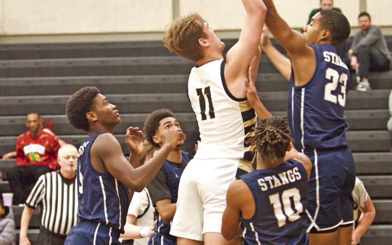 Root Shoots In a Crowd Brayden Root shoots over a Mustang defender Tuesday in Pirate Gym.