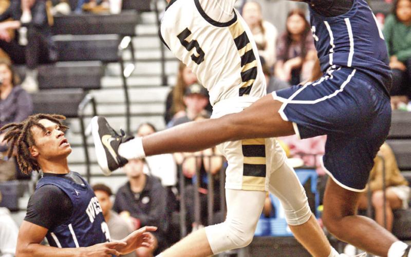 Fouled Bryce Loftin is fouled as he jumps for a shot Tuesday night versus West Orange Stark.