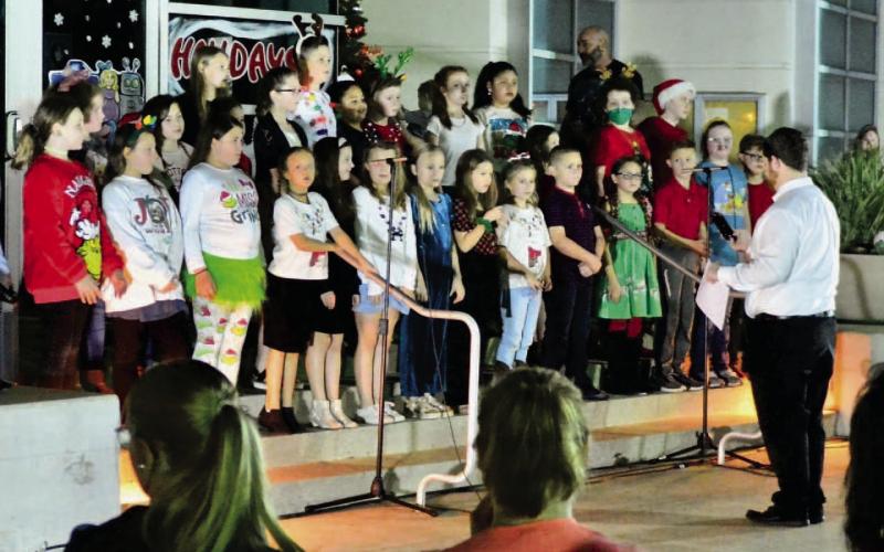 Pine Forest Elementary fourth grade choir students provided entertainment at the tree lighting event with a selection of favorite carols. Photo by Randall Luker