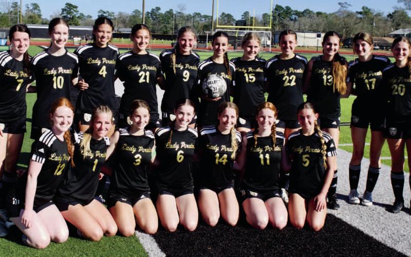 Record setting goal The Lady Pirate varsity soccer team poses with teammate Taylor Bull as she holds the game ball after breaking the single season scoring record for VHS.