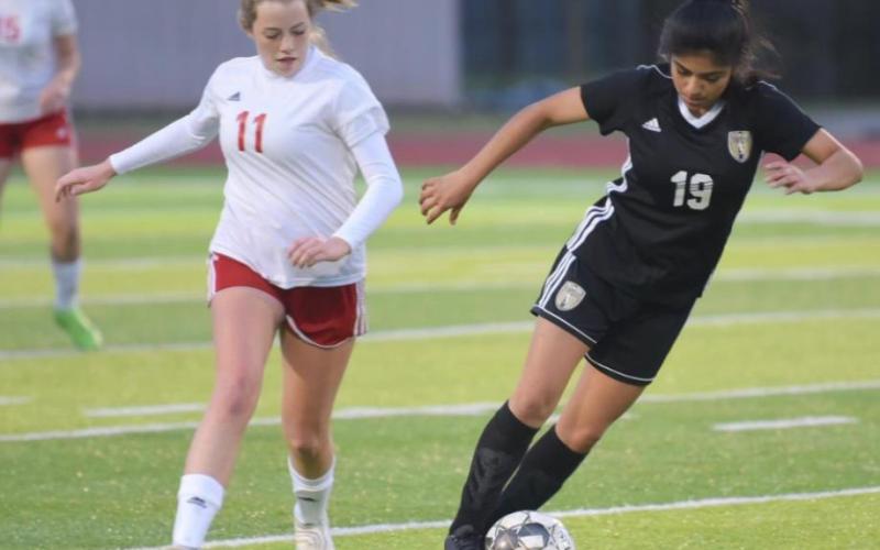 Junior Varsity Lady Pirate Catherine Gaspar dribbles past a Cleveland player Tuesday at pirate Stadium. Gaspar scored Vidor’s lone goal in a 9-1 loss. Photo by Randall Luker