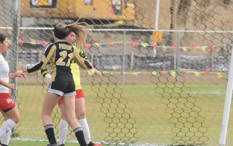 Lady Pirates celebrate as the ball hits the back of the net for a score. Photo by Randall Luker