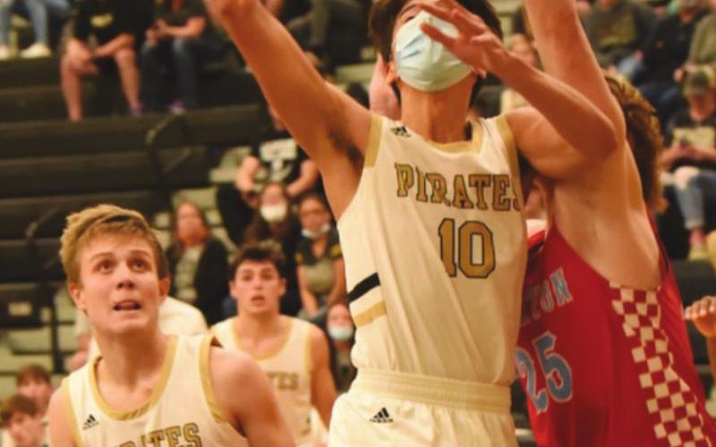 Aiden Ochoa, #10, takes a shot as #23, Easton Walker watches for a rebound. Dayton Whitmire is in the background. The Pirates lost 57-44.
