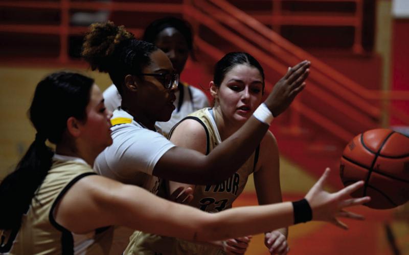 Kinsey Dillard, foreground, and Aubri Frasier battle for control under the basket versus LaMarque.