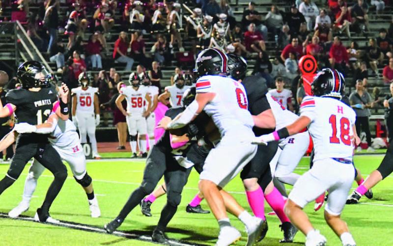 Under pressure Jett Brucia gets a pass off as a Falcon defender makes contact.