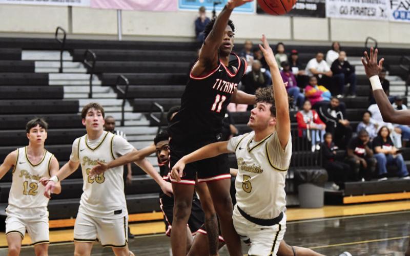 Bryce Loftin goes under a memorial defender to take a shot Friday at Pirate Gym.