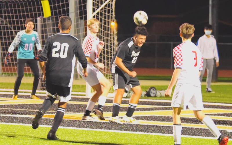 Varsity Pirates Aaron Guevara, #23 and Fidel Nava #20 work the ball at the Raider goal following a corner kick