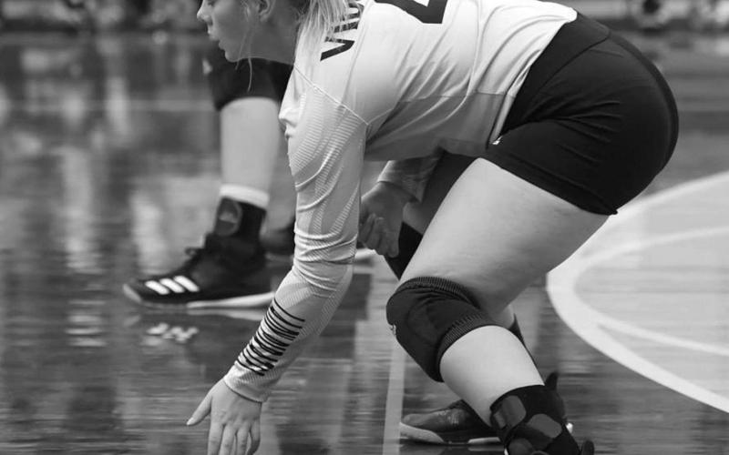 Aarilynne Richardson prepares to receive a serve. Photo by Randall Luker