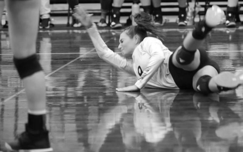 Andreya Garrett hits the floor hard as she goes for a dig against the Lady Hawks of Hardin Jefferson Tuesday night in Pirate Gym. Photo by Randall Luker
