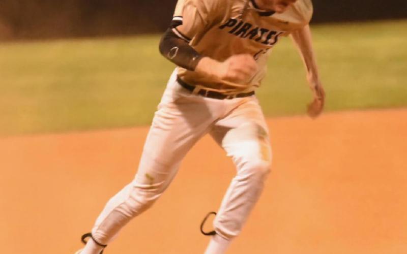 Regan Weiblinger puts his head down and heads for home plate in Friday’s game versus Bridge City. Photo by Randall Luker