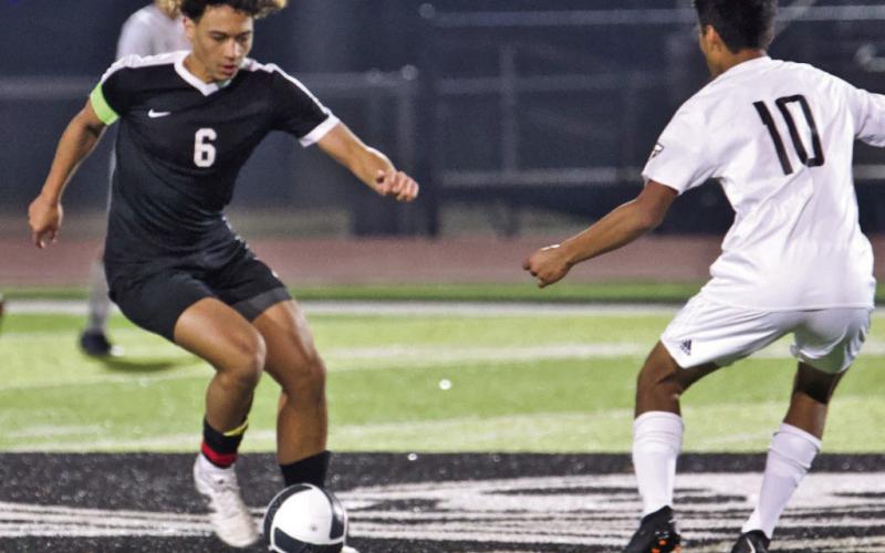 It’s all in the feet Rui Correia maneuvers past an Anahuac defender in Monday’s scrimmage. the Pirates won 7-0.