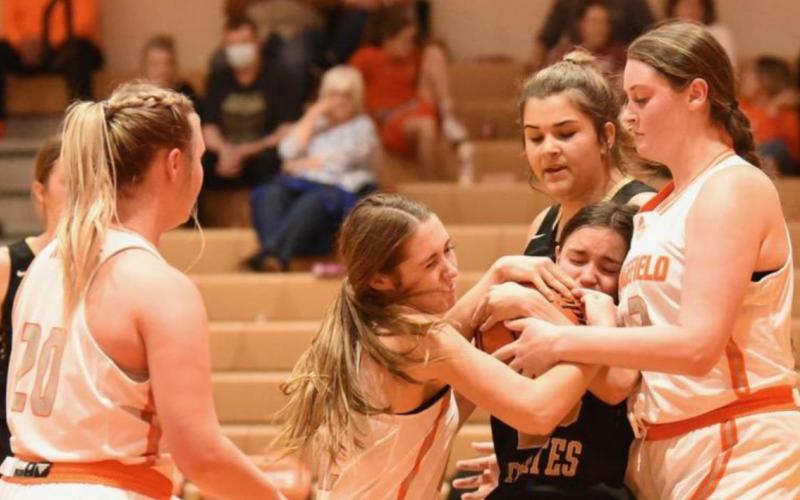 Lady Pirate Sofia Rodriguez is caught between two Lady Bobcats as she fights for control of the ball.