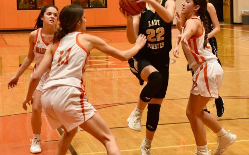 Junior varsity Lady Pirate Jaelyn Justice works her way through Orangefield defenders to take a shot in their district opener. Photos by Randall Luker