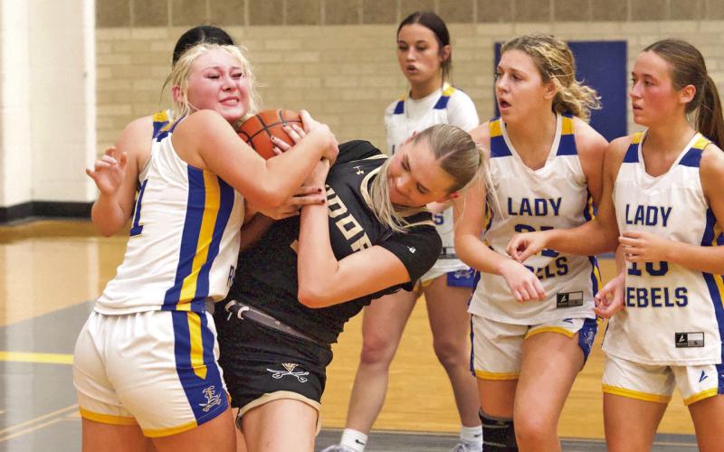 Battle for possession Vidor’s Raegan Stephenson battles with an Evadale Lady Rebel for possession of the ball during Tuesday night’s varsity game in Evadale. The Lady Pirates begin district play Friday in Lumberton.