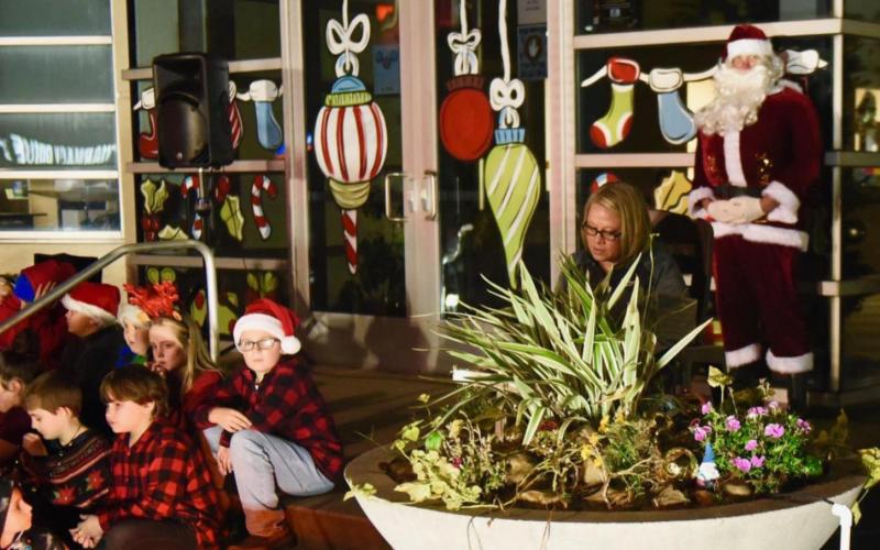 Children gather around to hear the mayor read "Twas The Night Before Christmas.