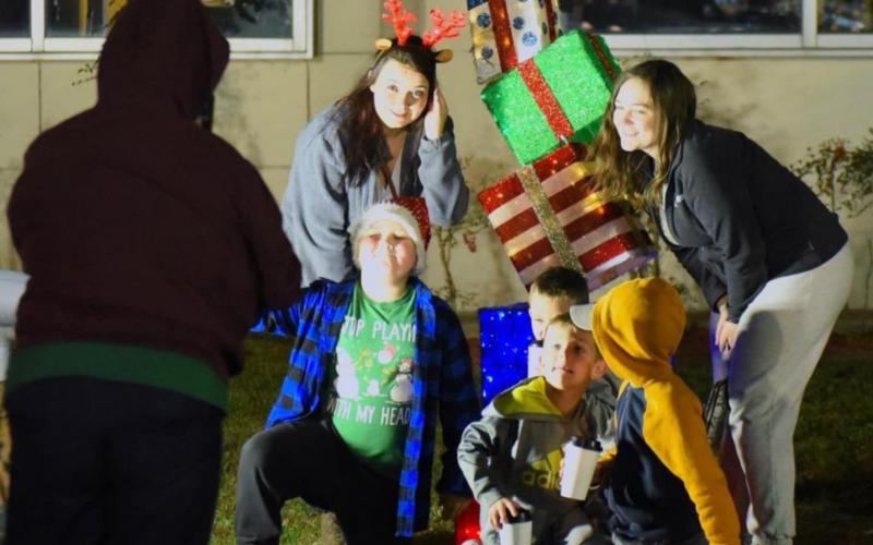 Family and friends enjoy picture taking around the Hometown Holiday Christmas decorations.