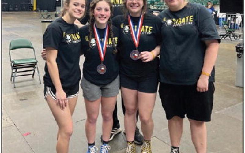 Head Girls Powerlifting Coach Rodney Burks stands behind Vidor Lady Pirate Powerlifter participating in this year’s State meet In Frisco. They are, L to R, Brianna Williams, Camryn Barragan, Madison Watson and McKenzie Teinert. Photo by Randall Luker