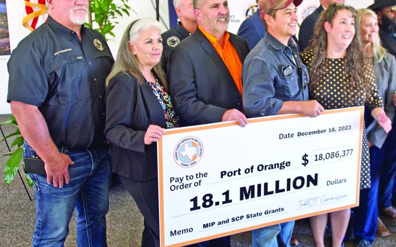 Port of Orange officials hold a facsimile check representing the historic $18.1 million in state funding that will repair and improve port facilities. Southeast Texas ports will share in a total of $66 million in state grant funding to improve port infrastructure.