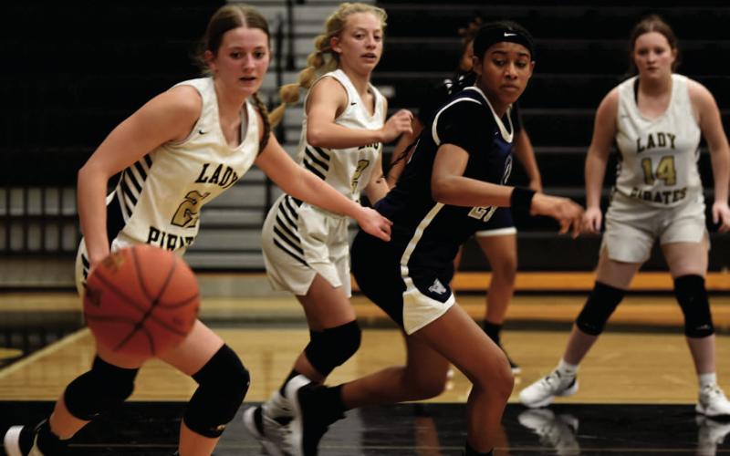 Madison Powell, Mia Robin and Carlie Abbott, left to right, keep an eye on an up for grabs ball lat week’s district matchup with The lady Mustangs of West Orange Stark. Photo by Randall Luker