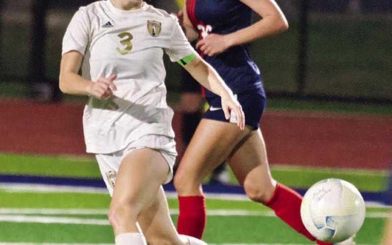 Hope Dilley keeps her eyes on the ball as she moves to intercept a Lady Hawk pass.