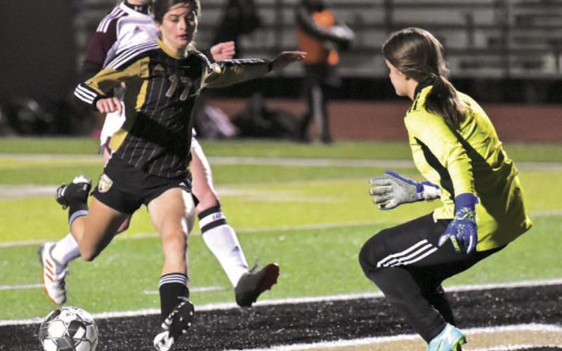 Jordyn Fowler kicks past the keeper to score for Vidor. Photo by Randall Luker