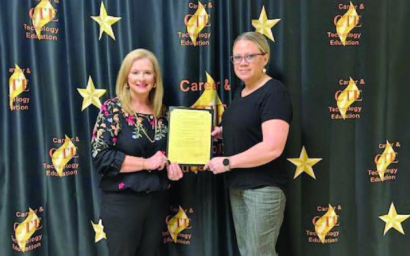 Pictured is Mayor Misty Hart presenting CTE Director Penny Singleton with a signed Proclamation Document