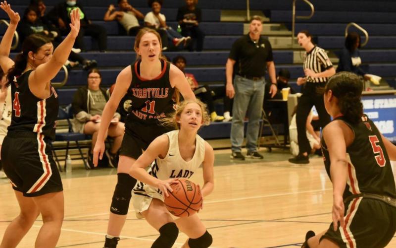 Mia Robin looks for her shot as she is surrounded by Kirbyville Lady Cats. Photo by Randall Luker