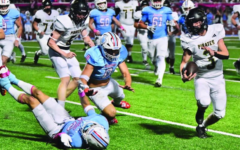 Pirate RB Landon Jones eludes the Raider defense on his way to a touchdown Friday night in Lumberton.