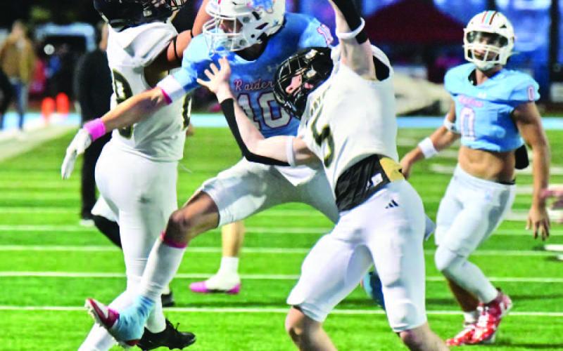 A Lumberton defender swats a Daigan Venable pass away from Pirate receivers Skylar Stankovich and Braden Norton.