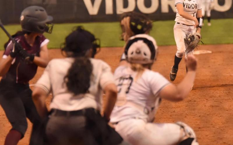 Keaira McCurley sends the ball toward home plate versus Silsbee. Photo by Randall Luker