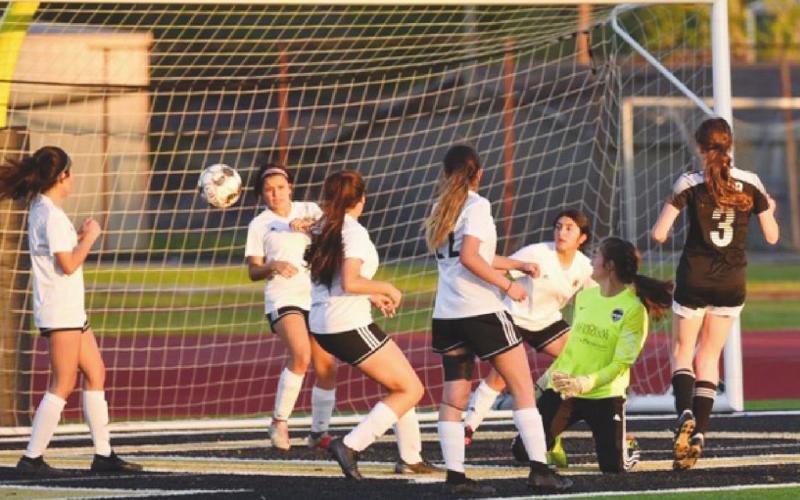 Lady Panthers watch as Lady Pirate Maryn Chilton’s, right #3, kick sails by for Vidor’s third goal in their playoff game Thursday.
