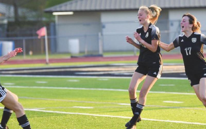 Lady Pirates, usual order, Naomi Collier, Kendra Long and Amelia Wright celebrate after Long centered a shot on a virtually unattended goal.