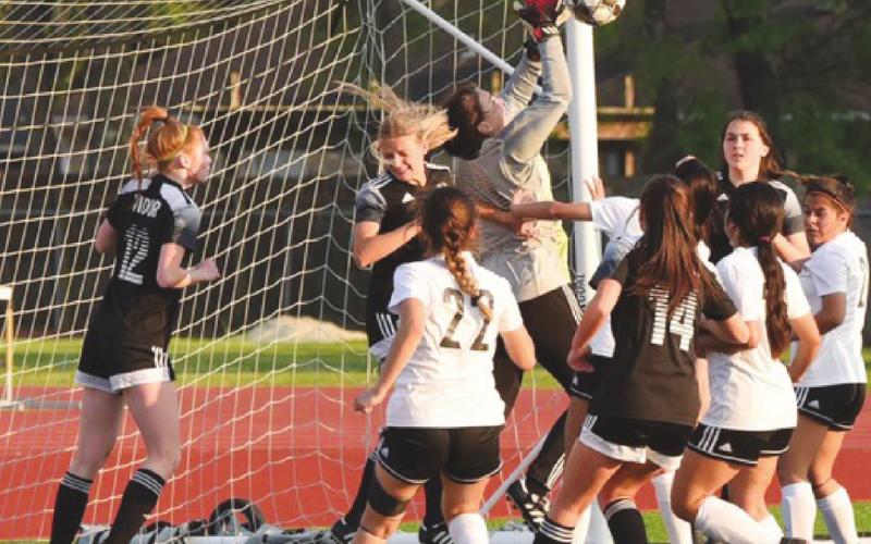 Lady Pirate goalkeeper Audrey Tilley grabs the ball to prevent a score in Thursday’s playoff game with Liberty. Helping Tilley defend are #12, Mallory Martin, Brooklyn Healy, to Tilley’s right, #14 Bailey Phelan and Alaina Davis, far right.