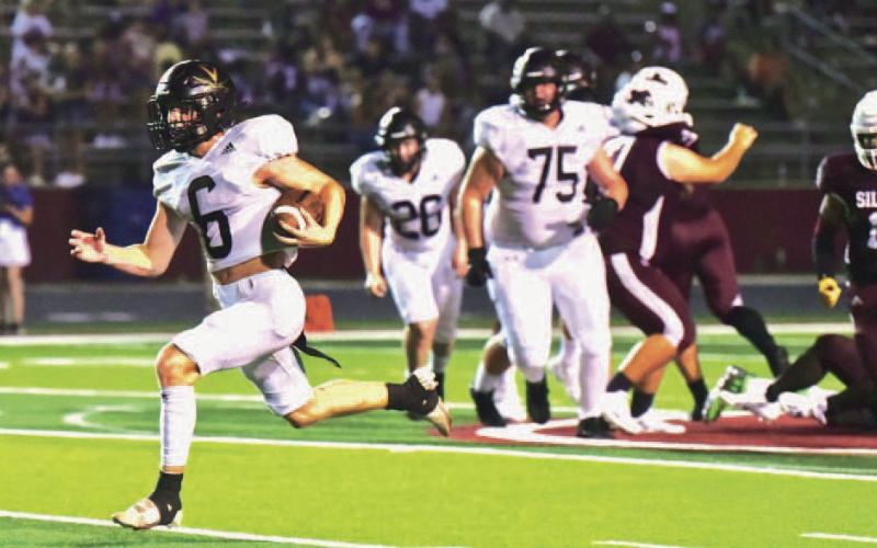 The left side of Vidor’s offensive line opened a big hole in the Tigers’ defensive line to free Dane Villadsen for a 40 yard pickup to the 10 yard line Friday at Tiger Stadium. Photo by Randall Luker