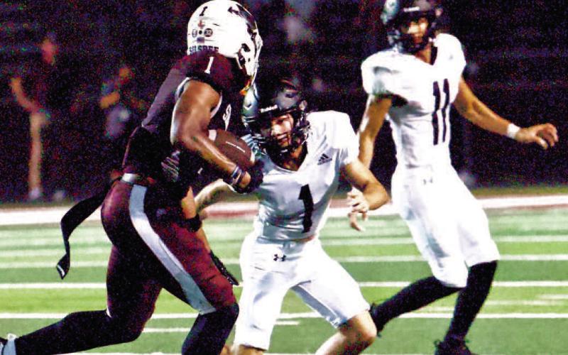 Vidor’s #1, Westin Baker, sets up to take Silsbee’s #1, Dre’lon Miller while Vidor Pirate #11, Bryce Dubose backs him up. Photo by Randall Luker