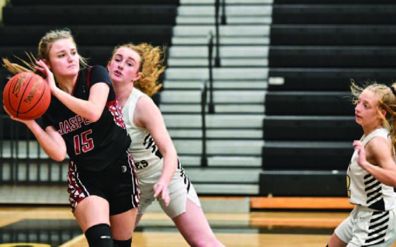 Lady Pirates Natalie Morrison, center, and Mia Robin, right, pressure a Jasper Lady Dawg as she looks to pass Friday at Pirate Gym. Photo by Randall Luker
