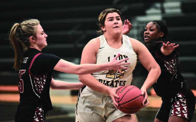Laikyn Brodnax eyes the basket as she readies her shot as a Jasper player reaches in. Photo by Randall Luker